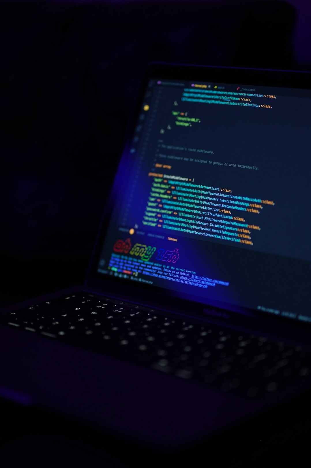 programmer writing code on laptop