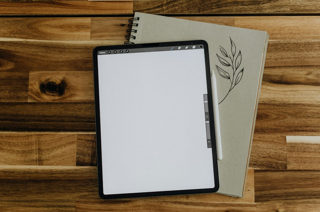 Tablet displaying charts next to insurance paperwork on a desk
